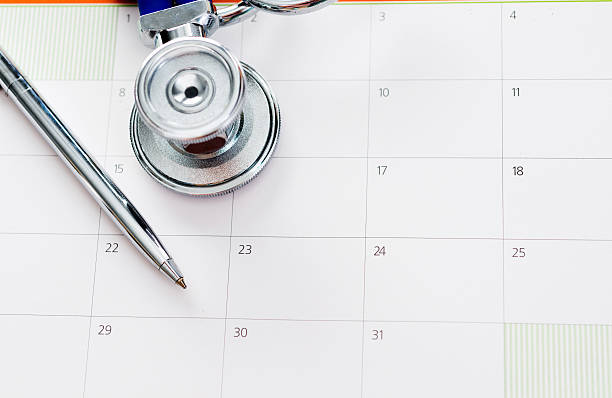 istock Stethoscope and pen on calendar 593303298