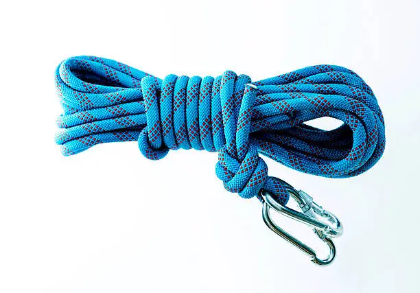 Blue climbing rope isolated on white background.