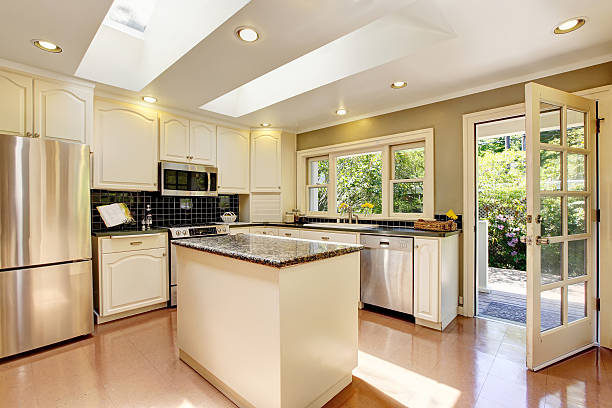 istock White kitchen with granite tops. Kitchen island and tile floor. 593304594