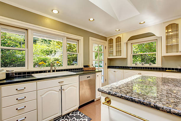 istock White kitchen with granite tops. Kitchen island and tile floor. 593304742