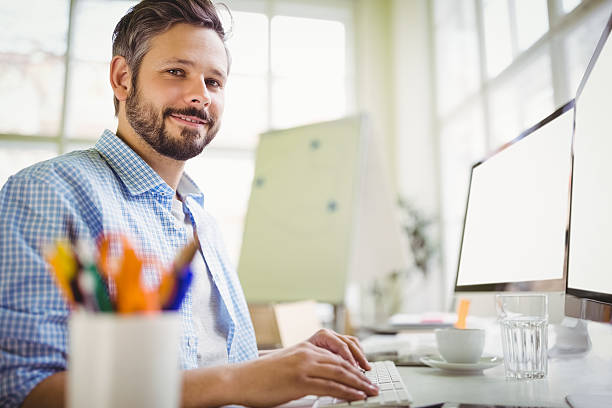 istock Portrait of young businessman working in creative office 593305288