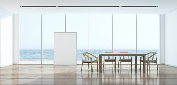 istock Sea view dining room in modern house with picture frame 593305320