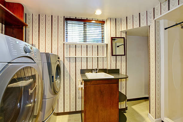 istock Old style laundry room with modern appliances and vintage wallpaper. 593306162
