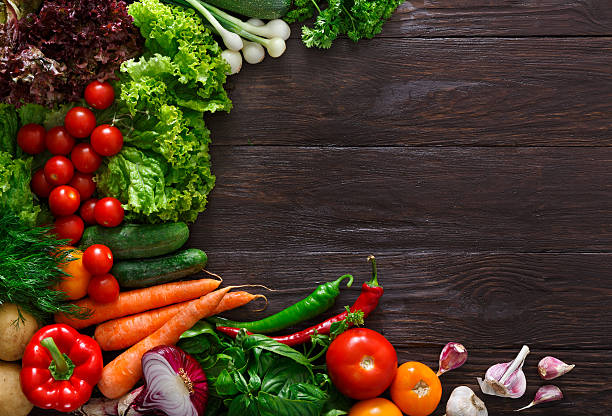 istock Frame of fresh vegetables on wooden background with copy space 593306244