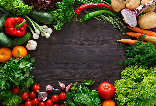 istock Frame of fresh vegetables on wooden background with copy space 593306320