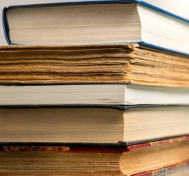 istock close up of stack of books on grey background 593306472