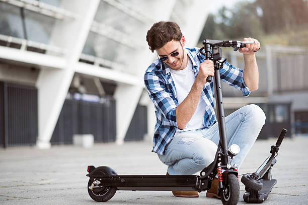 istock Pleasant delighted man holding kick scooter 593306600