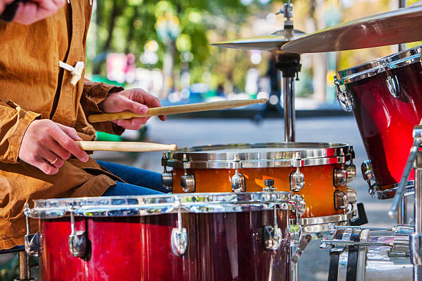 Performance of street musicians Music street performers on autumn park outdoor. Middle section of body part. Drums foreground in autumn park. bass drum photos stock pictures, royalty-free photos & images
