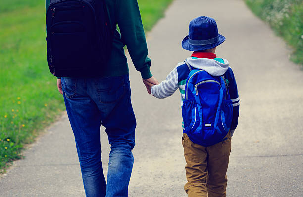 istock father walking son to school or daycare 593307570