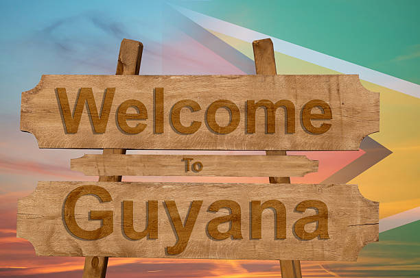 istock Welcome to Guyana sing on wood background with national flag 593308702