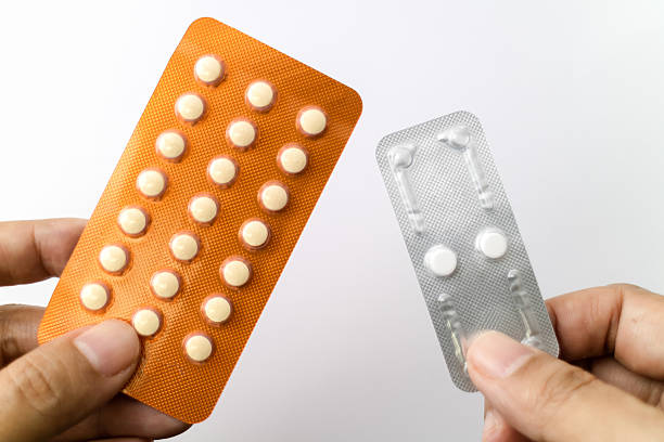 Oral contraceptive pills and Morning after pills in woman hands. Oral contraceptive pills and Morning after pills in woman hands, Blisters of birth control pills. Abortion problem concept morning after pill stock pictures, royalty-free photos & images