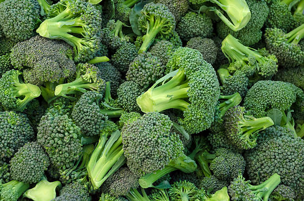 Broccoli in a pile Broccoli in a pile on a market broccoli stock pictures, royalty-free photos & images