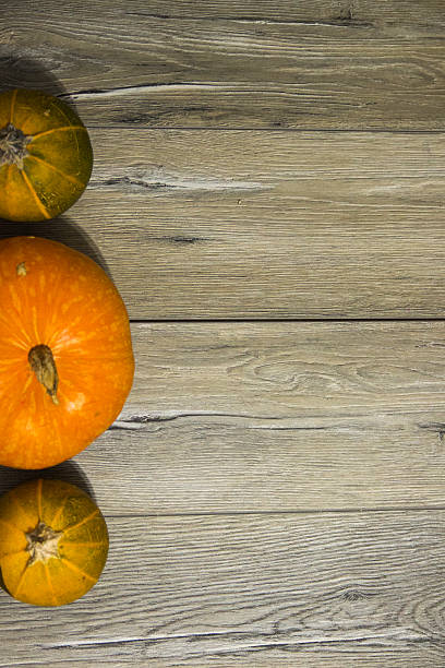 istock Pumpkins on a wooden table 593310818