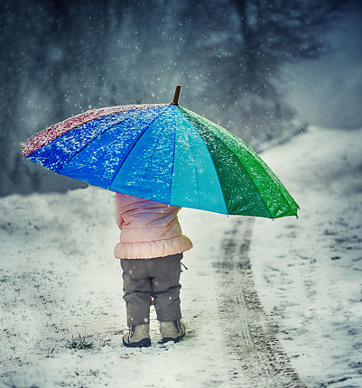 Little Girl With Umbrella in a Winter Cloudy Day