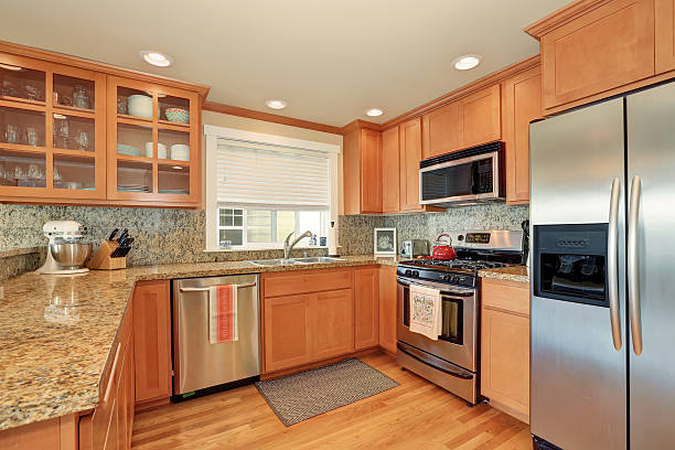 istock Bright wooden kitchen interior with steel appliances 593313180