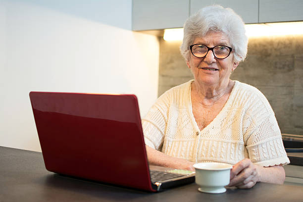 istock Senior woman using laptop computer at home. 593314322