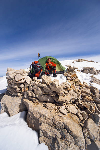 istock Winter camping in the mountains with a backpack and tent. 593317134