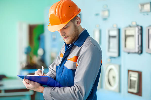 portrait of young engineer taking notes at control room - manual worker portrait helmet technology imagens e fotografias de stock