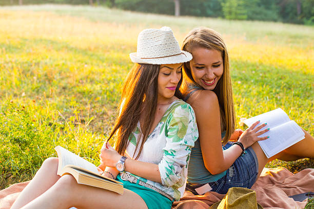 istock Young smiling women relaxing in nature and studying 593318964