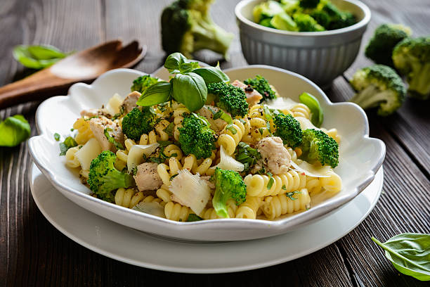 Pasta salad with chicken meat, broccoli, cheese and basil