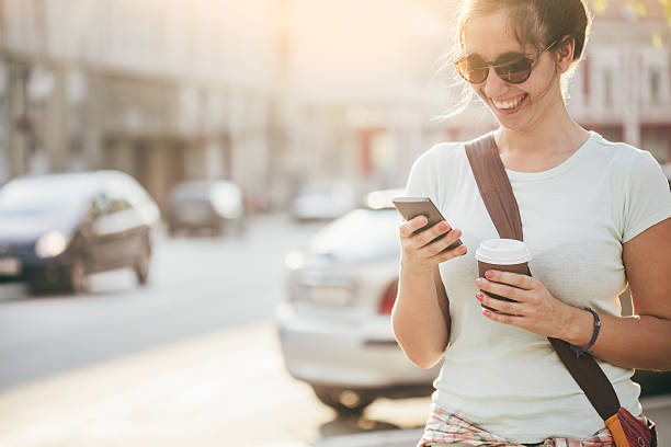 istock Young woman in the city reading a text message 593321920