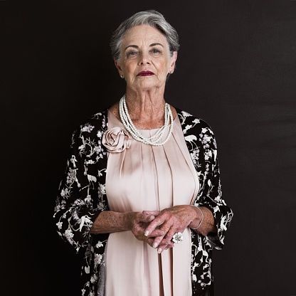 Cropped studio portrait of a grand old lady isolated on black