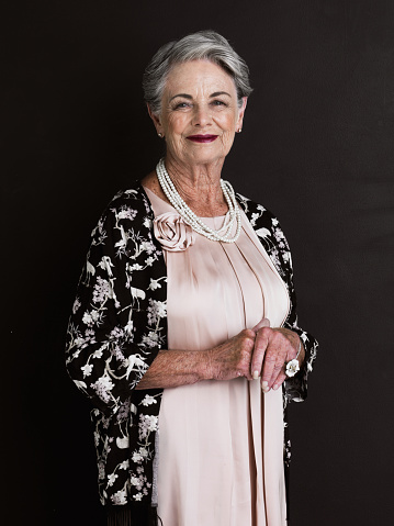 Cropped studio portrait of a grand old lady isolated on black