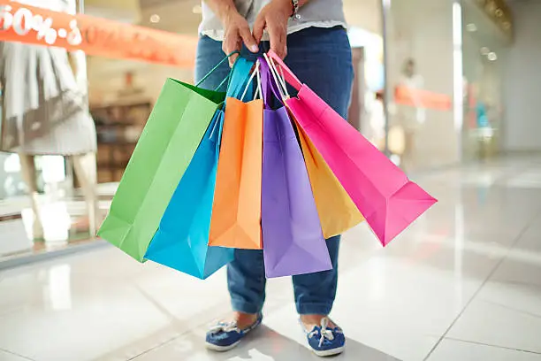 Paperbags held by mature shopper