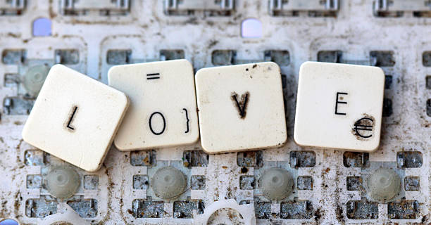 istock some keys on a dirty yellowed keyboard. text love 593327066