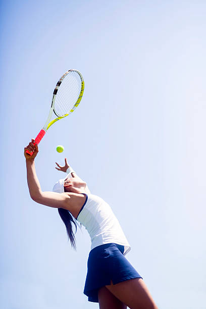 istock Beautiful female tennis player serving 593327328