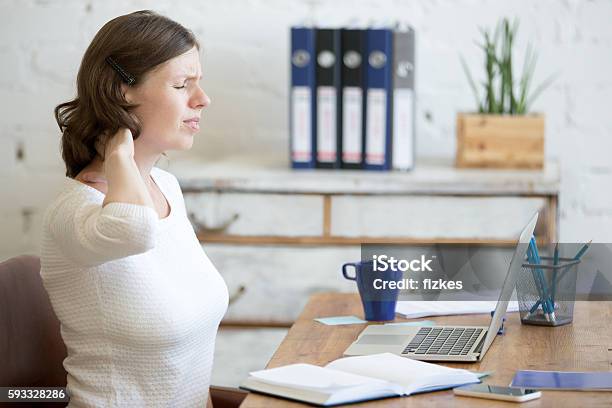 Young Office Woman Feeling Pain In The Neck Stock Photo - Download Image Now - Occupation, Physical Therapy, Cramp