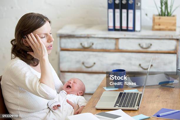 Portrait Of Young Business Mom Having Headache Because Of Crying Stock Photo - Download Image Now