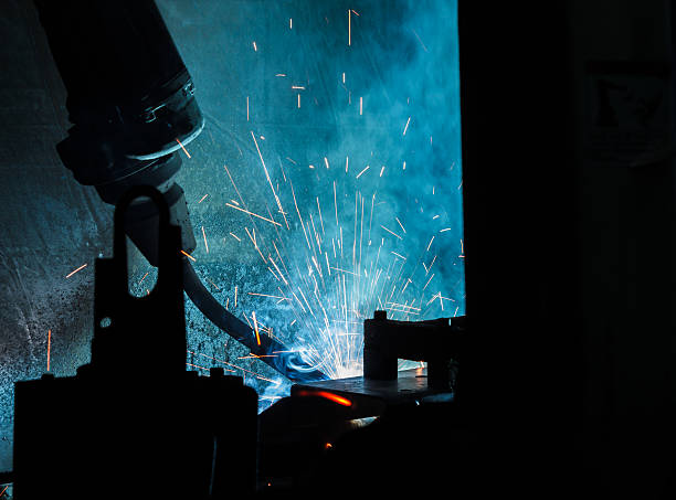 istock Welding robots movement in a car factory 593329774