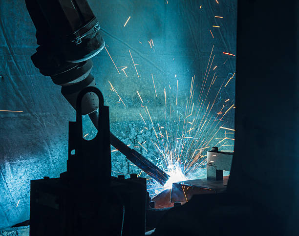 istock Welding robots movement in a car factory 593329820