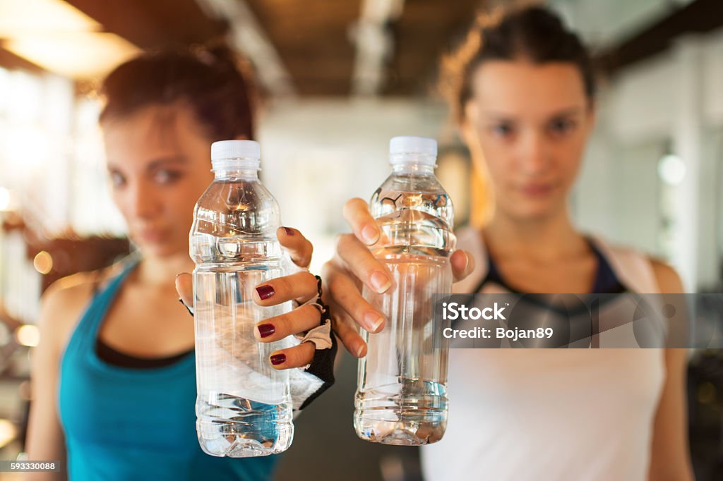 Young Fitness Women With Water Bottles Focus On The Bottles Stock Photo -  Download Image Now - iStock
