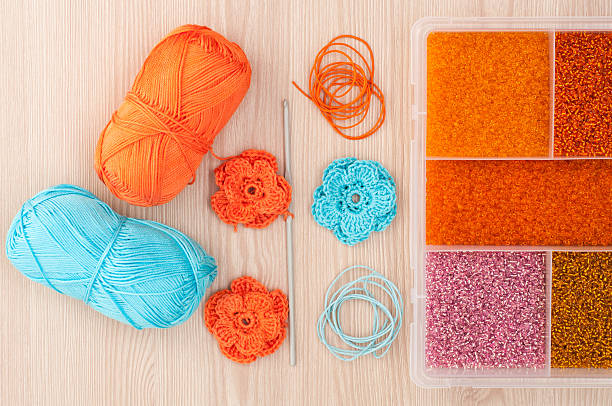 istock Handmade knitted crochet flowers and box with beads 593330094