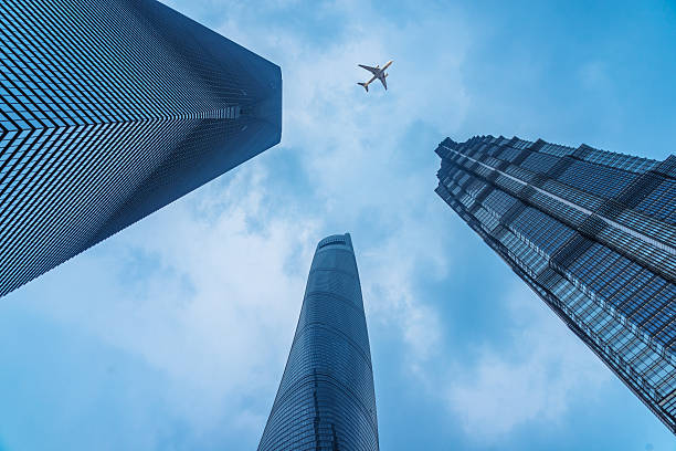 istock plane flying over the skyscrapers 593331982