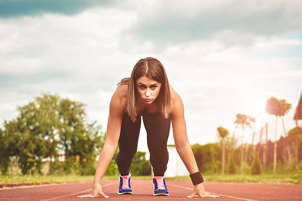 istock Athletic woman on track starting to run 593332536