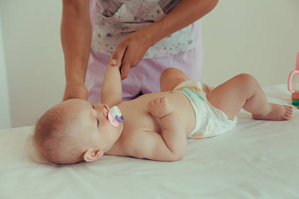 istock Masseur doing massage a small baby. 593332562