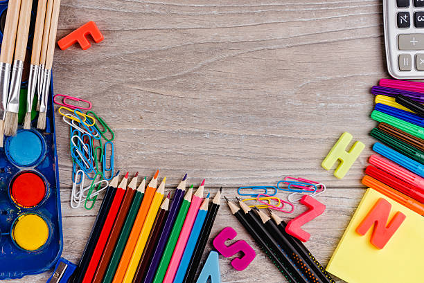 istock School supplies on wood background 593333412