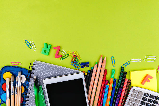 istock School supplies on green background 593335362