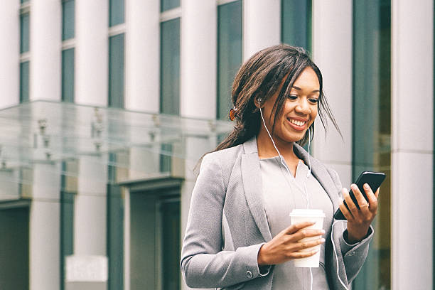 Portrait Of Successful Businesswoman During Coffee Break Portrait of successful businesswoman during coffee break holding a cup of freshly brewed coffee and talking on the phone. cityscape videos stock pictures, royalty-free photos & images