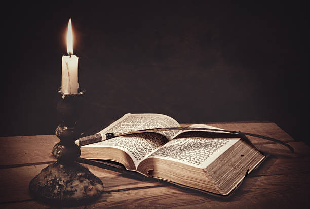 istock Old fashioned backgrounds with opened Holy Bible 593336056