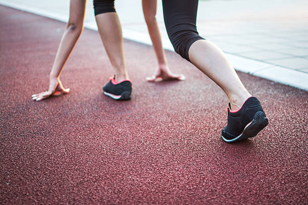 istock Young female runner feet on track. 593336962