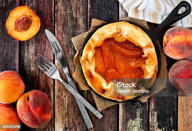 Fresh Peach Tart In Cast Iron Skillet Over Rustic Wood Stock Photo - Download Image Now