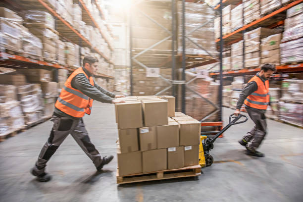 istock Motion blur of two men moving boxes in a warehouse 593337788