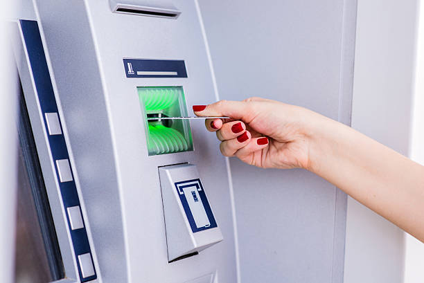 istock Woman inserting a credit card to ATM 593338294