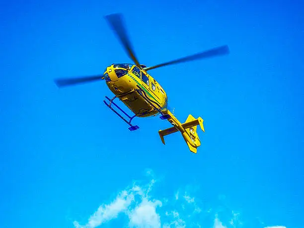 Air Ambulance helicopter in the sky above Sherborne, UK