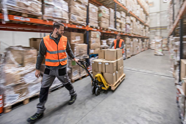 istock Motion blur of two men moving boxes in a warehouse 593341996