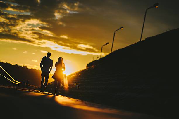 Free Stock Photo of Two people walking on the street at sunset ...